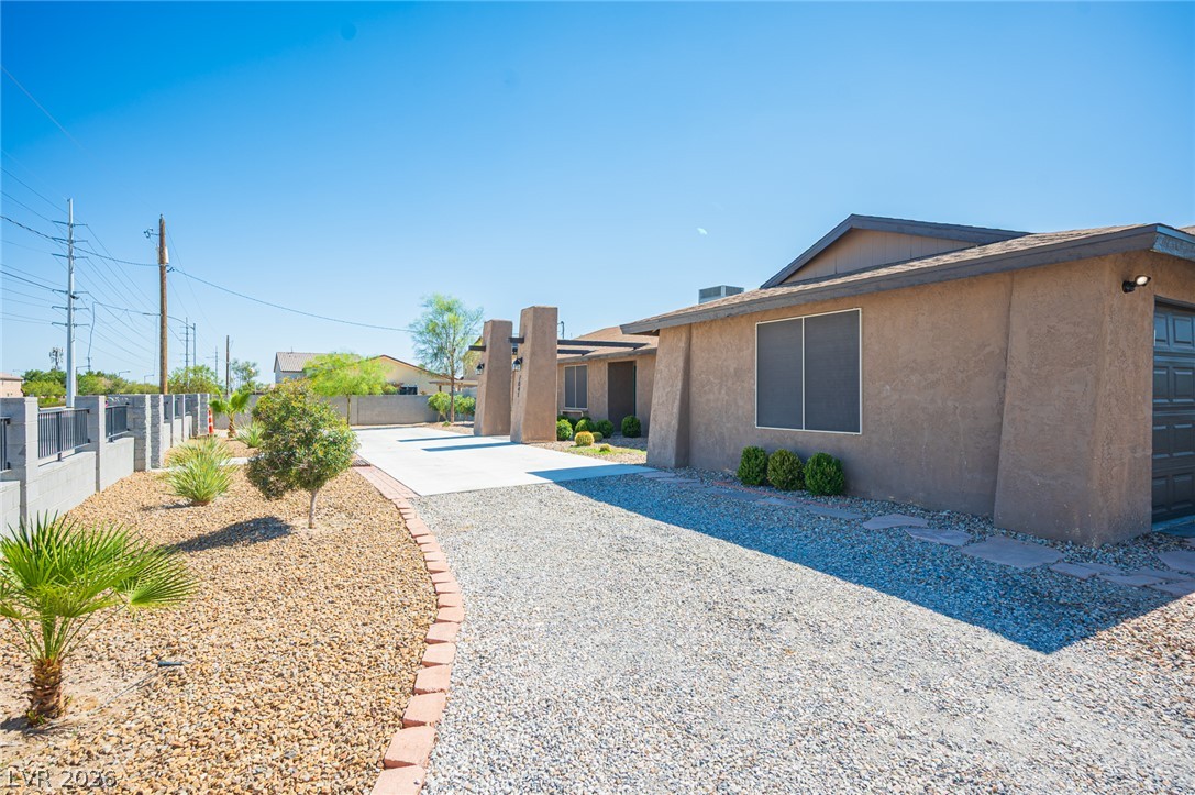 7041 North Decatur Boulevard Las Vegas, NV 89131 - Photo 29 of 33 A well-maintained desert landscape and gravel driveway complement this sturdy stucco residence.