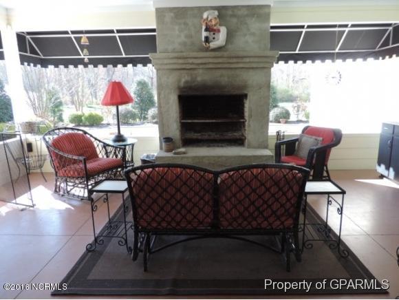613 Academy Heights Road Kinston, NC 28504 - Photo 23 of 49 Outdoor covered patio with stone fireplace that converts to grill