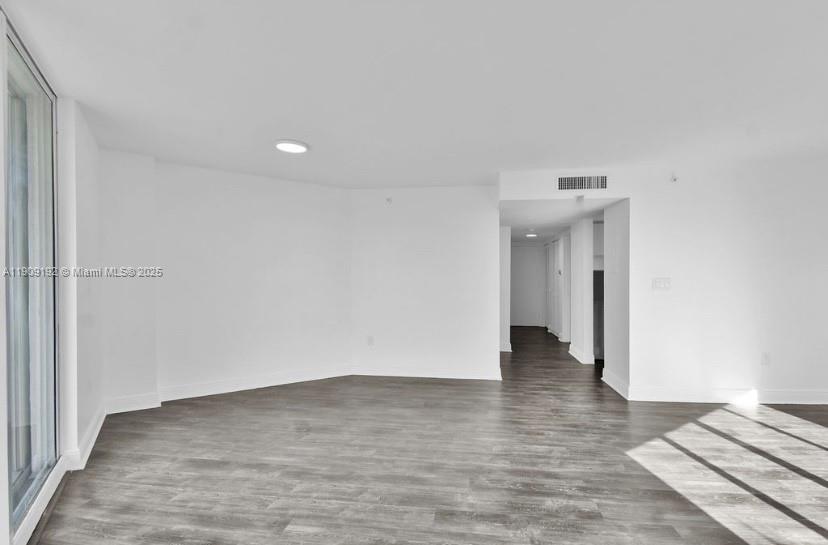 1688 West Avenue, Unit 602 Miami Beach, FL 33139 - Photo 11 of 61 a view of an empty room with wooden floor and a window