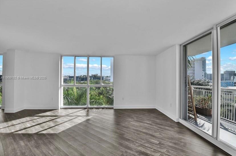 1688 West Avenue, Unit 602 Miami Beach, FL 33139 - Photo 16 of 61 a view of wooden floor and windows in a room
