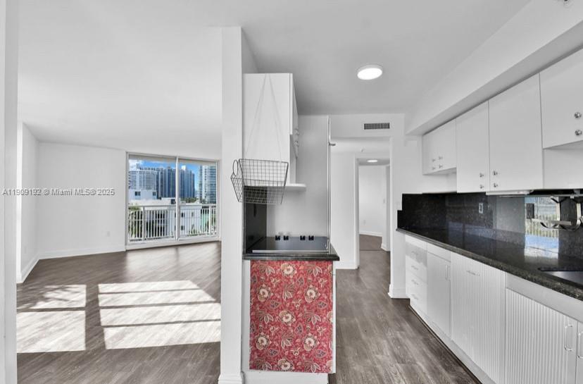 1688 West Avenue, Unit 602 Miami Beach, FL 33139 - Photo 20 of 61 a large kitchen with stainless steel appliances kitchen island granite countertop a refrigerator and a stove top oven