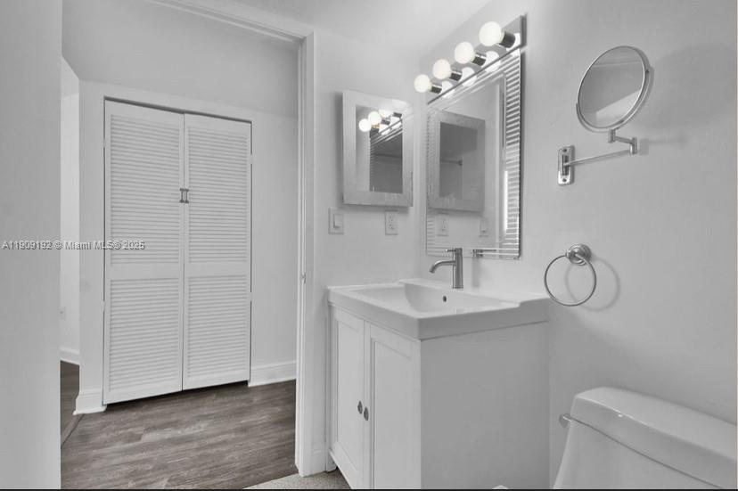 1688 West Avenue, Unit 602 Miami Beach, FL 33139 - Photo 33 of 61 a bathroom with a toilet sink and mirror
