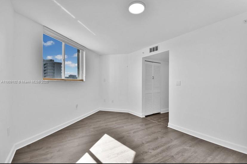 1688 West Avenue, Unit 602 Miami Beach, FL 33139 - Photo 38 of 61 an empty room with wooden floor and windows