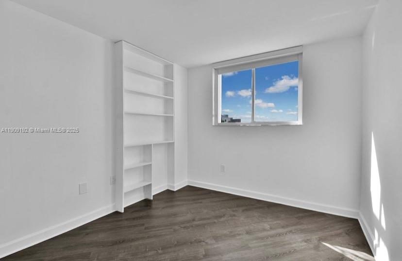 1688 West Avenue, Unit 602 Miami Beach, FL 33139 - Photo 47 of 61 a view of an empty room with wooden floor and a window