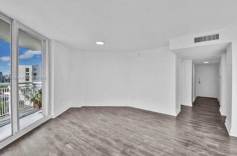 1688 West Avenue, Unit 602 Miami Beach, FL 33139 - Photo 10 of 61 a view of an empty room with wooden floor and a window