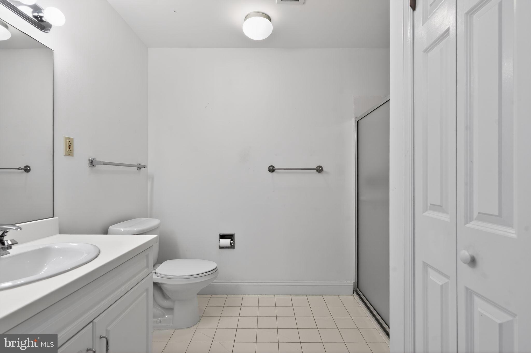 2205 Windrow Drive Princeton, NJ 08540 - Photo 16 of 24 a bathroom with a granite countertop toilet a sink and a mirror