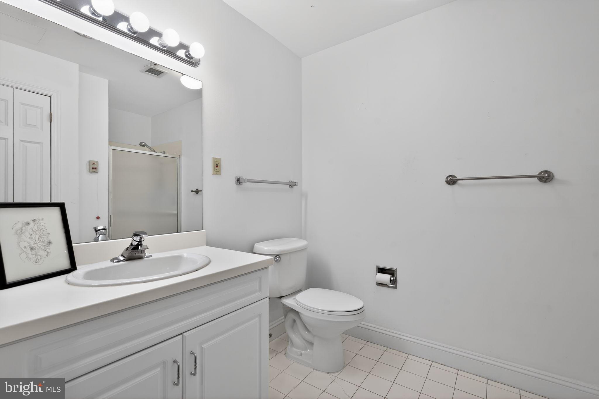2205 Windrow Drive Princeton, NJ 08540 - Photo 17 of 24 a bathroom with a toilet a sink and mirror