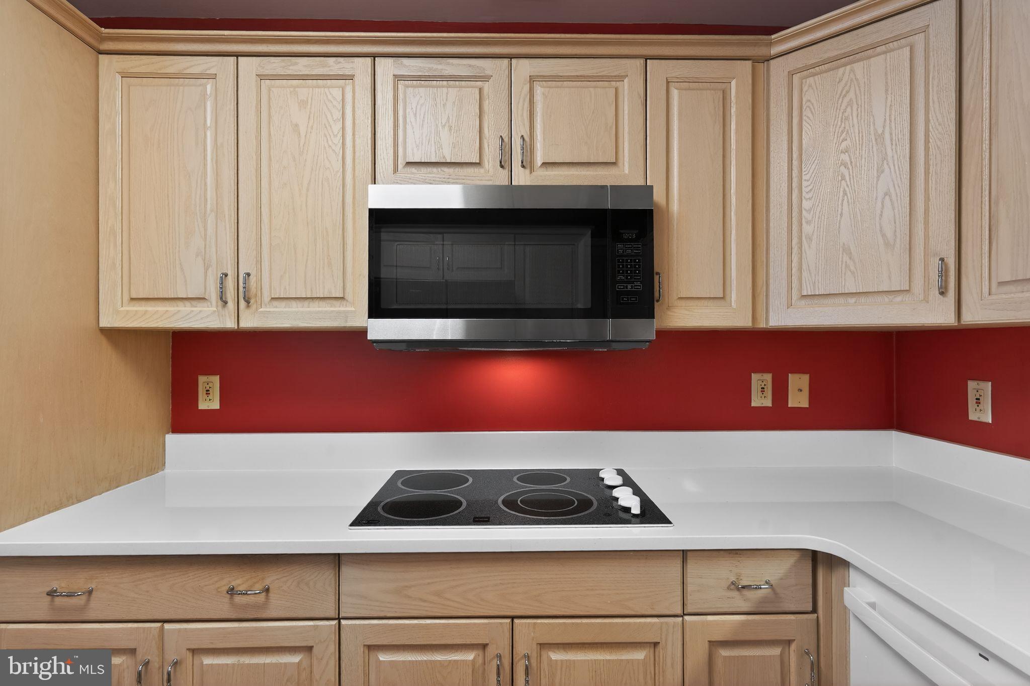 2205 Windrow Drive Princeton, NJ 08540 - Photo 9 of 24 a kitchen with granite countertop white cabinets and black appliances