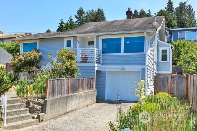 9340 45th Avenue Southwest Seattle, WA 98136 - Photo 1 of 33 a front view of a house with a garden