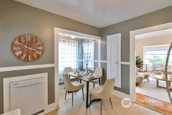 9340 45th Avenue Southwest Seattle, WA 98136 - Photo 14 of 33 a dining room with furniture and a floor to ceiling window