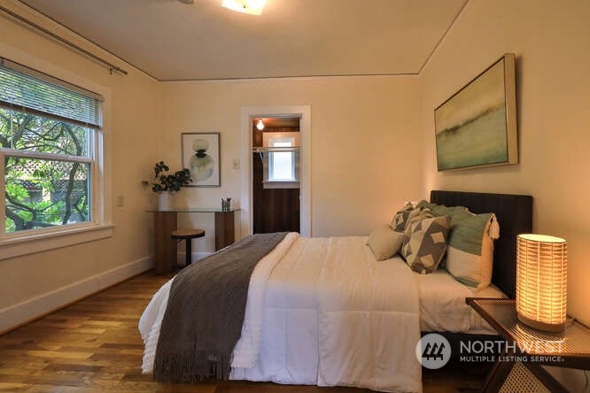 9340 45th Avenue Southwest Seattle, WA 98136 - Photo 24 of 33 a bedroom with a bed and wooden floor
