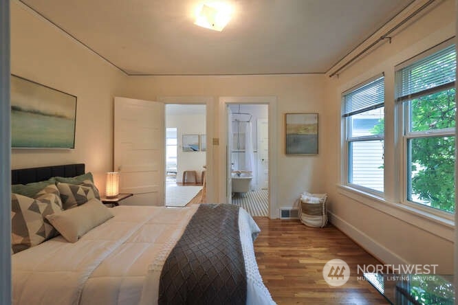 9340 45th Avenue Southwest Seattle, WA 98136 - Photo 25 of 33 a bedroom with a large bed and a window