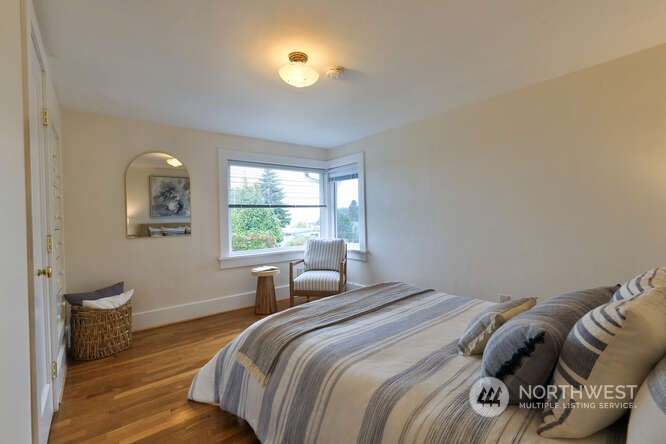 9340 45th Avenue Southwest Seattle, WA 98136 - Photo 27 of 33 a bedroom with a bed and a window