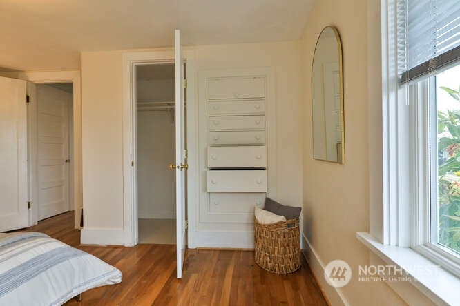 9340 45th Avenue Southwest Seattle, WA 98136 - Photo 29 of 33 a bedroom with a bed and wooden floor