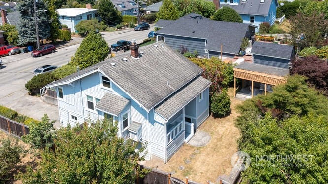 9340 45th Avenue Southwest Seattle, WA 98136 - Photo 5 of 33 an aerial view of a house with a yard and table and chairs under an umbrella