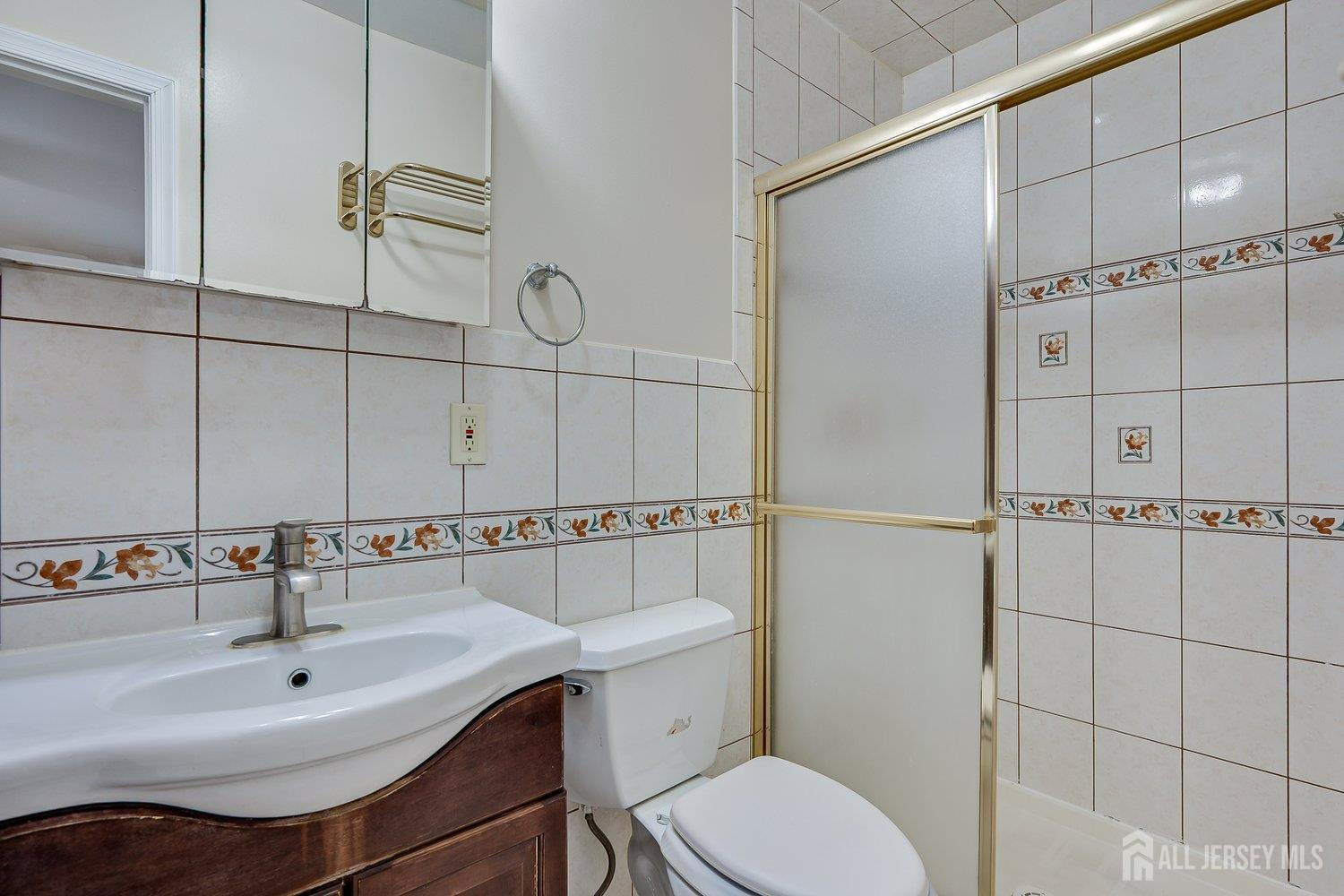 7 Lily Court Edison, NJ 08820 - Photo 18 of 32 a bathroom with a sink toilet and shower