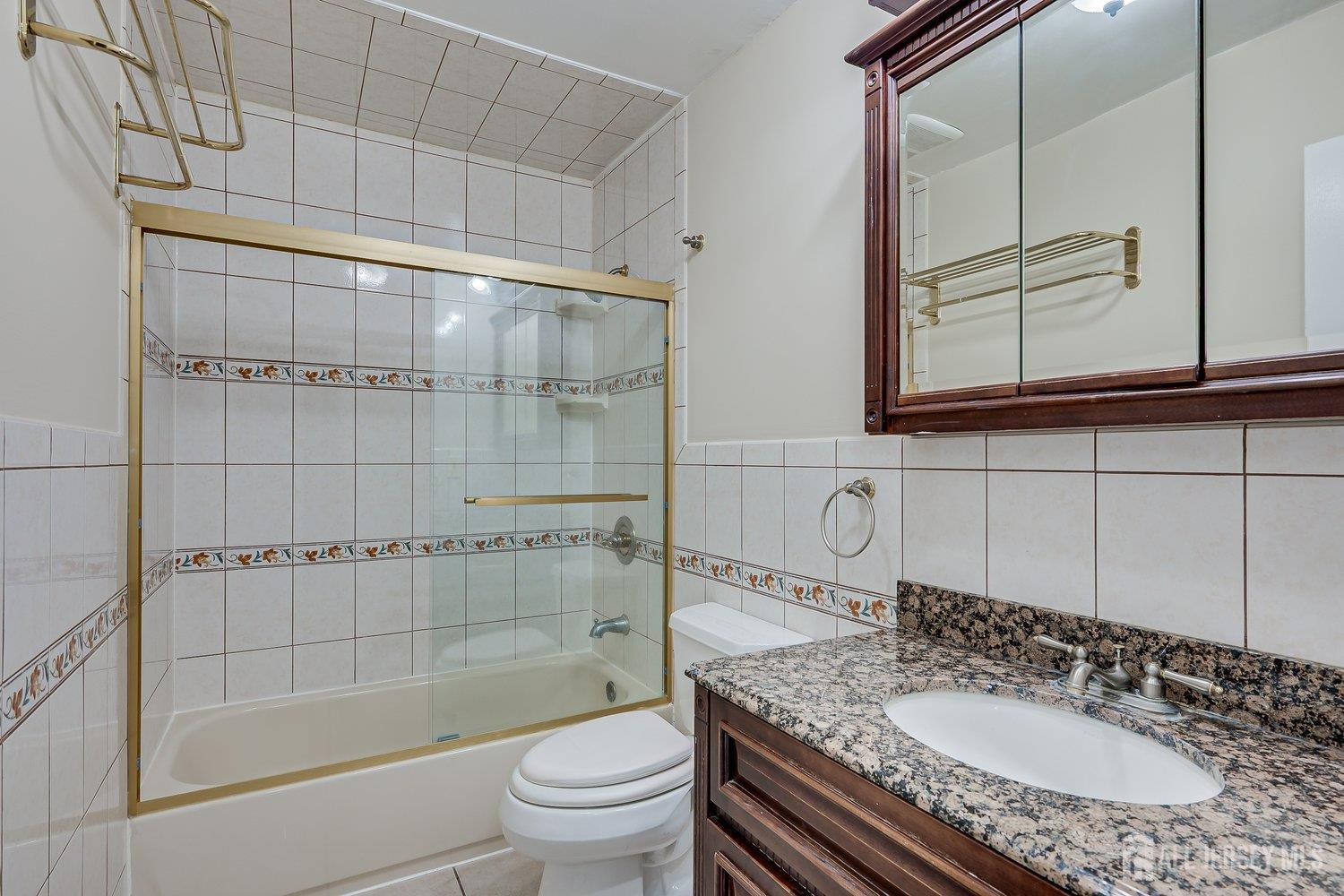 7 Lily Court Edison, NJ 08820 - Photo 23 of 32 a bathroom with a sink a toilet and shower