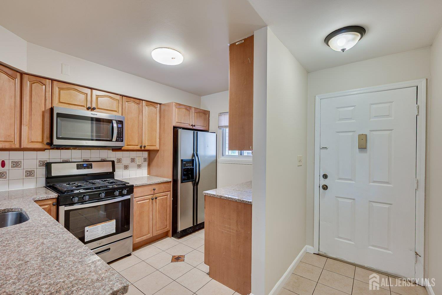 7 Lily Court Edison, NJ 08820 - Photo 3 of 32 a kitchen with stainless steel appliances a refrigerator and a stove top oven