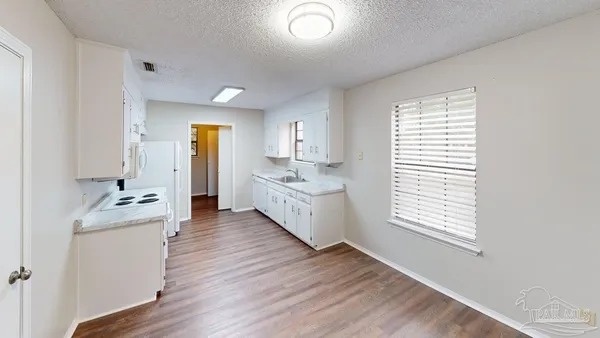 a room with a bed and a dresser
