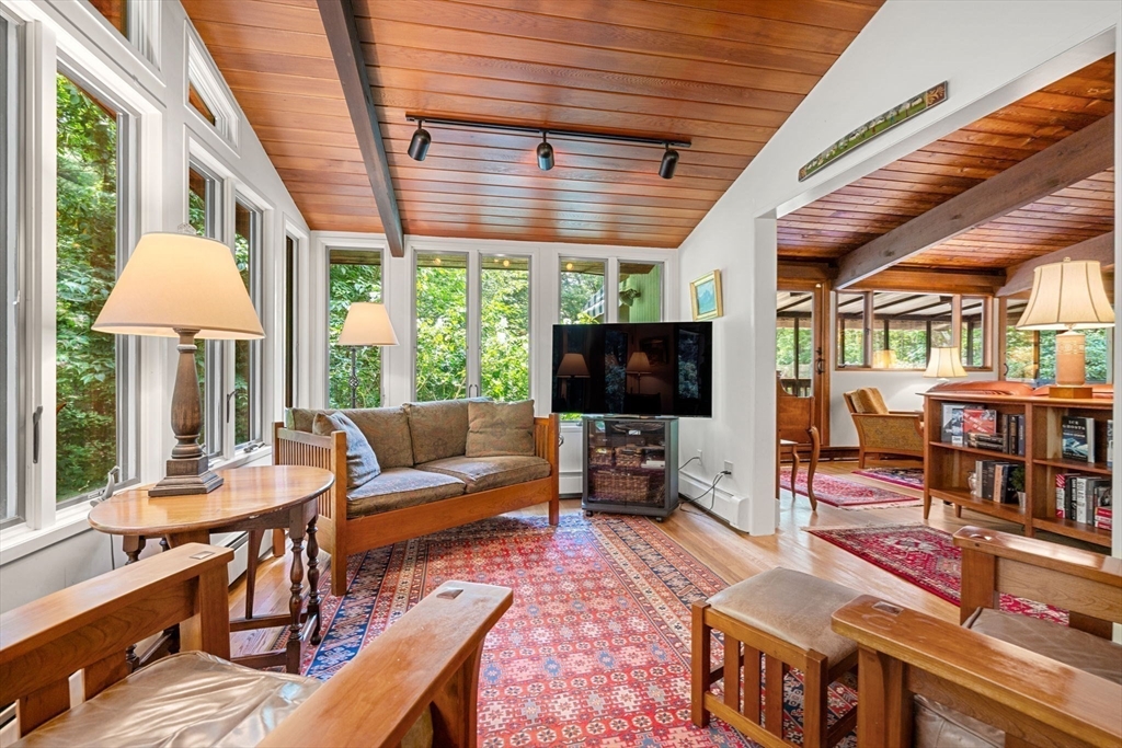 60 Pine Street Dover, MA 02030 - Photo 12 of 36 a living room with furniture a flat screen tv and a large window
