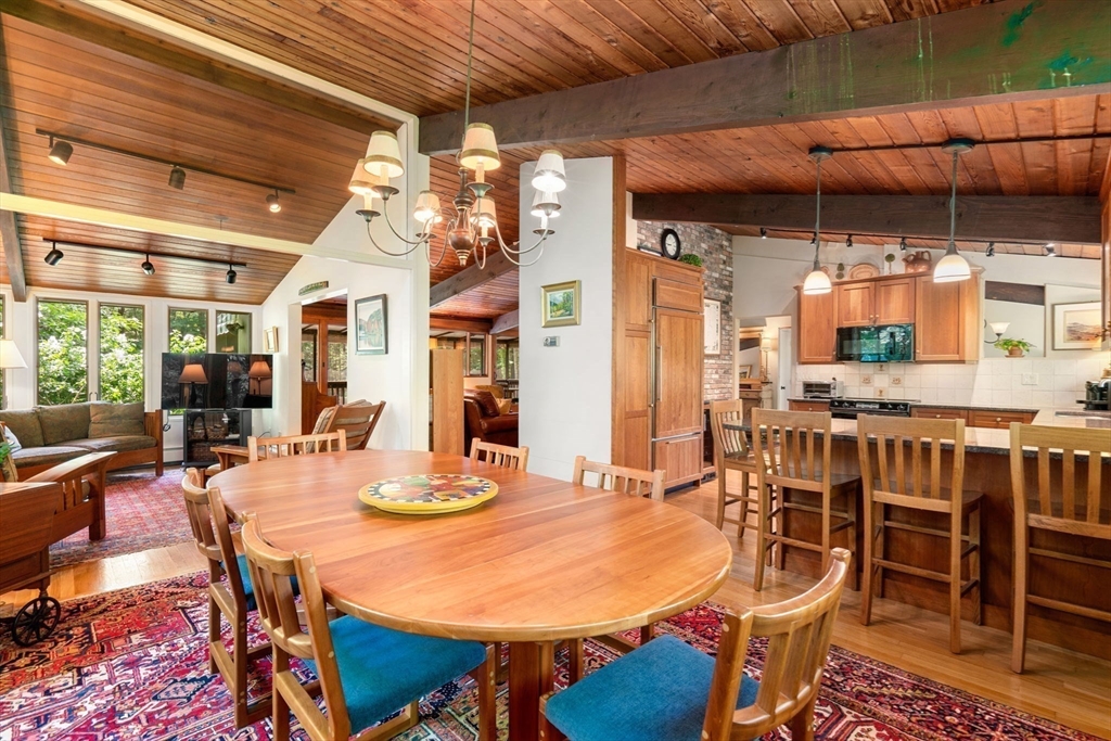 60 Pine Street Dover, MA 02030 - Photo 15 of 36 a dining room with furniture a chandelier and wooden floor