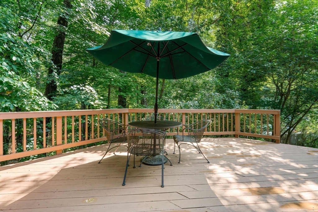 60 Pine Street Dover, MA 02030 - Photo 18 of 36 a view of a chair and table on the deck