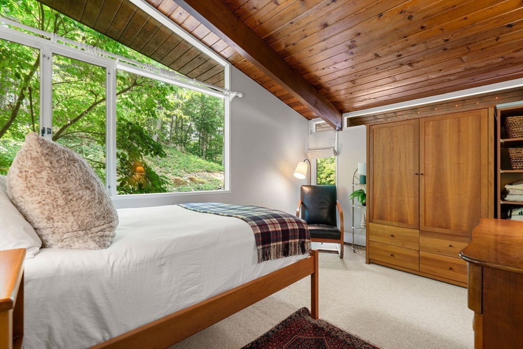 60 Pine Street Dover, MA 02030 - Photo 20 of 36 a bedroom with a bed dresser and a window