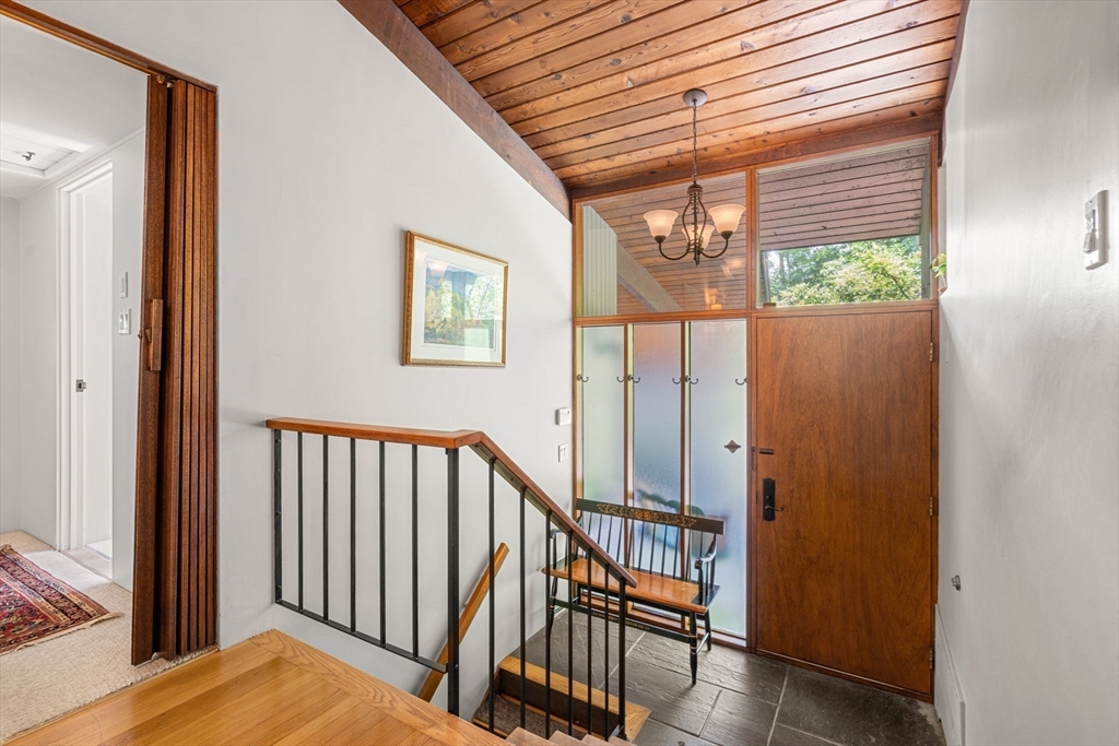 60 Pine Street Dover, MA 02030 - Photo 26 of 36 a view of a hallway with wooden floor and stairs
