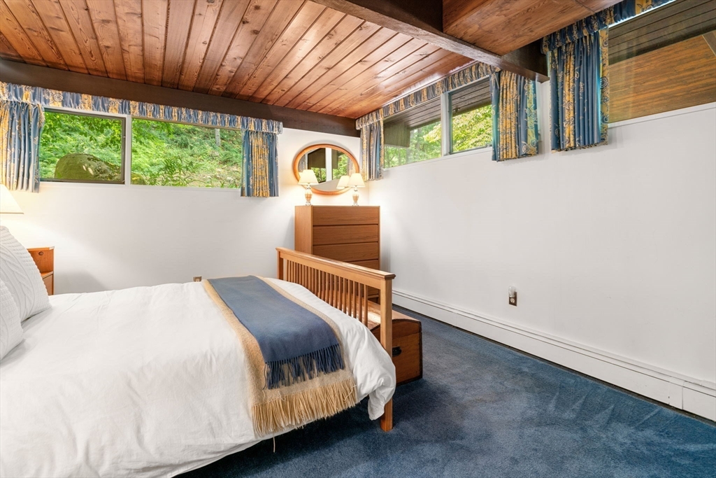 60 Pine Street Dover, MA 02030 - Photo 31 of 36 a bed sitting in a bedroom next to a window