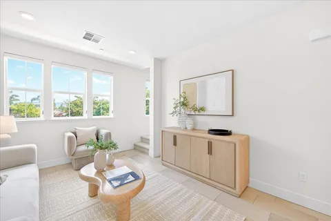 a living room with furniture kitchen and a window