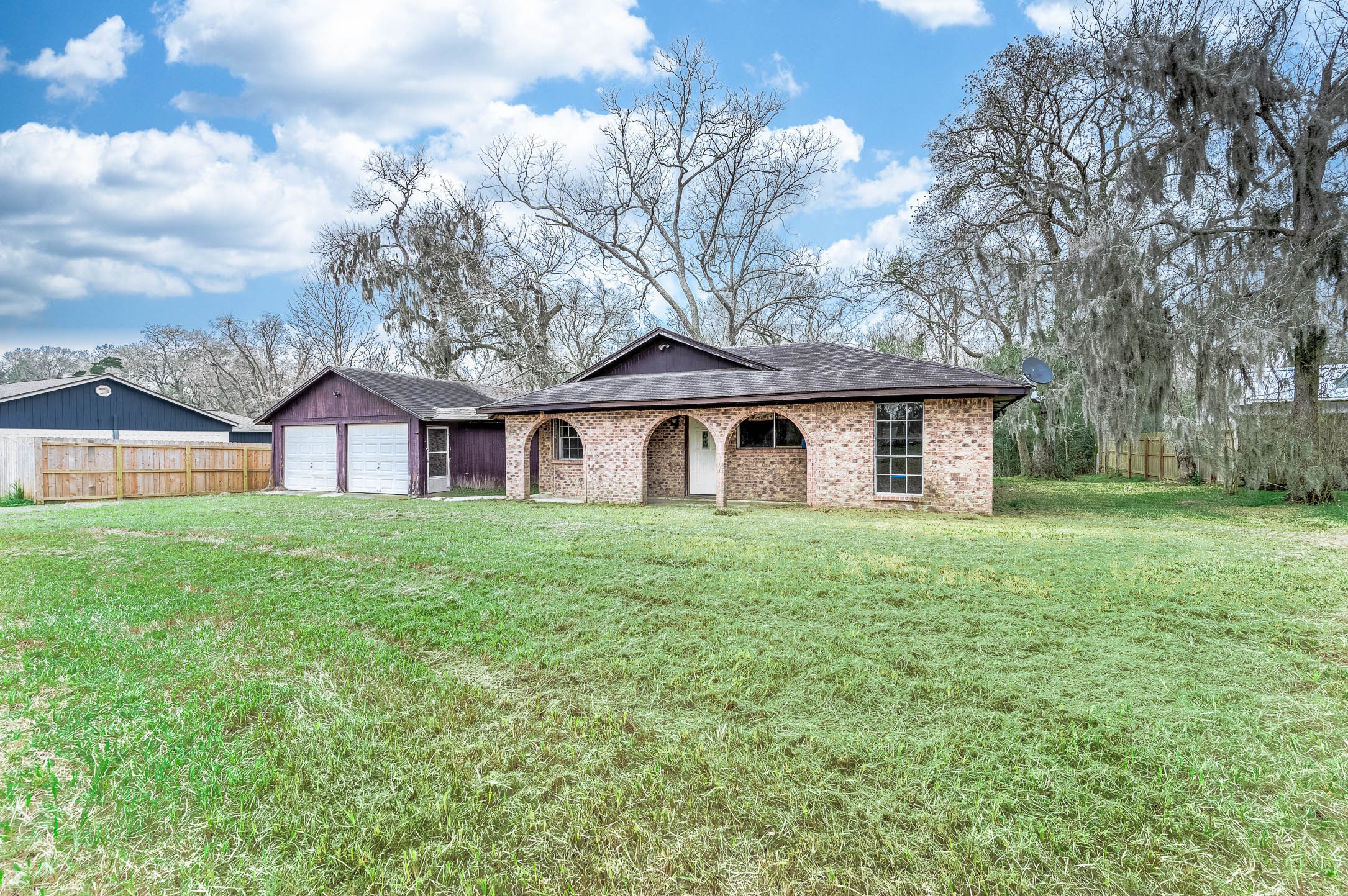 1431 County Road 934 Sweeny, TX 77480 - Photo 2 of 21 a view of a yard in front of a house with large trees