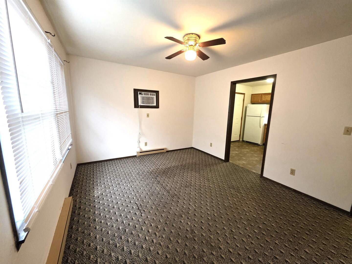 331 West Main Street Olney, IL 62450 - Photo 11 of 58 an empty room with wooden floor and windows
