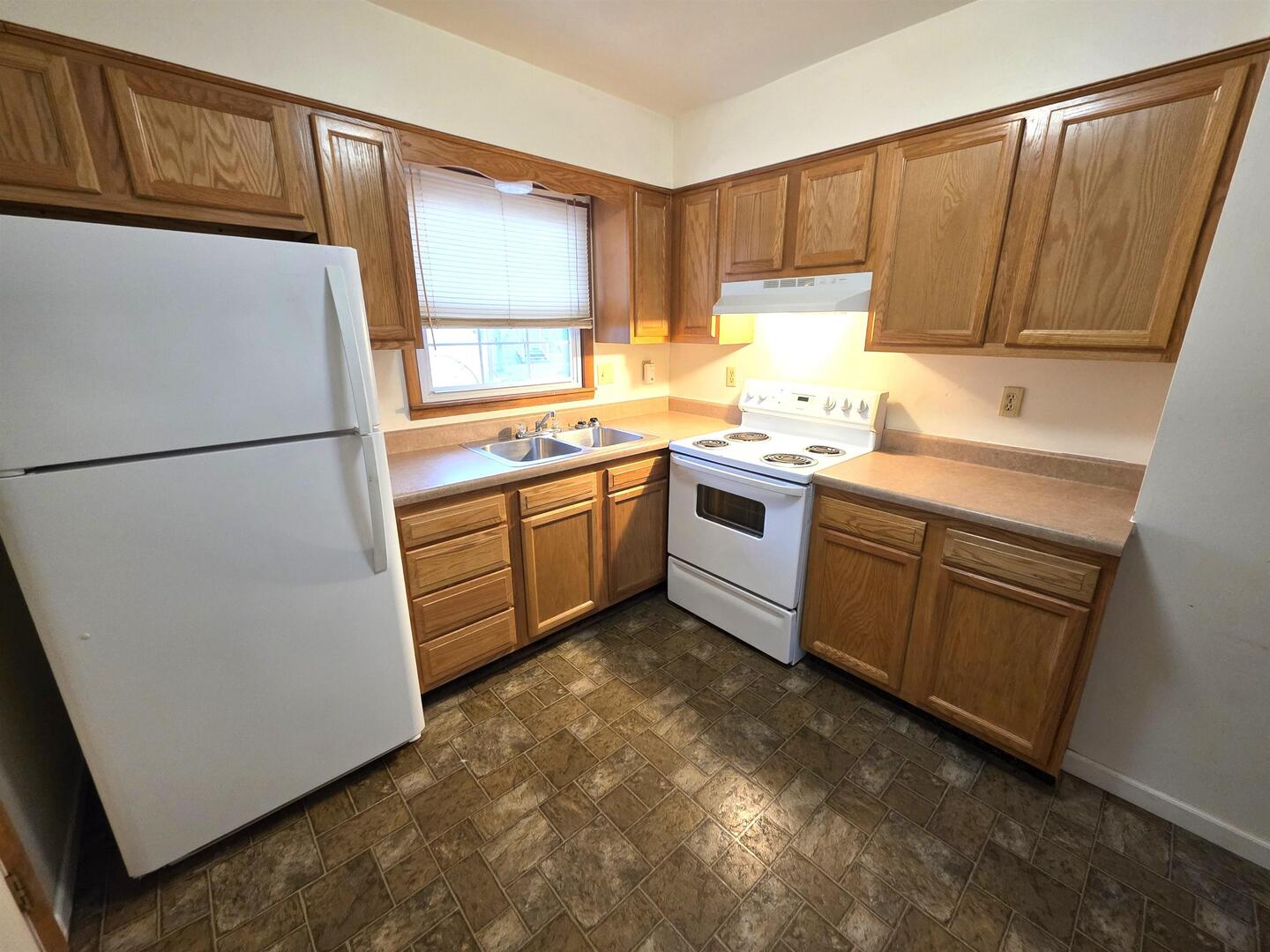 331 West Main Street Olney, IL 62450 - Photo 12 of 58 a kitchen with sink a refrigerator and cabinets