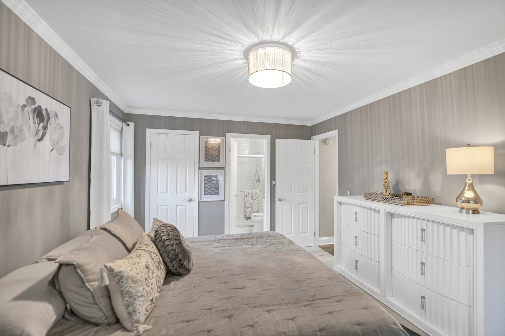 1256 Plum Tree Court, Unit D1 Schaumburg, IL 60193 - Photo 13 of 40 a bedroom with a large bed and a chandelier