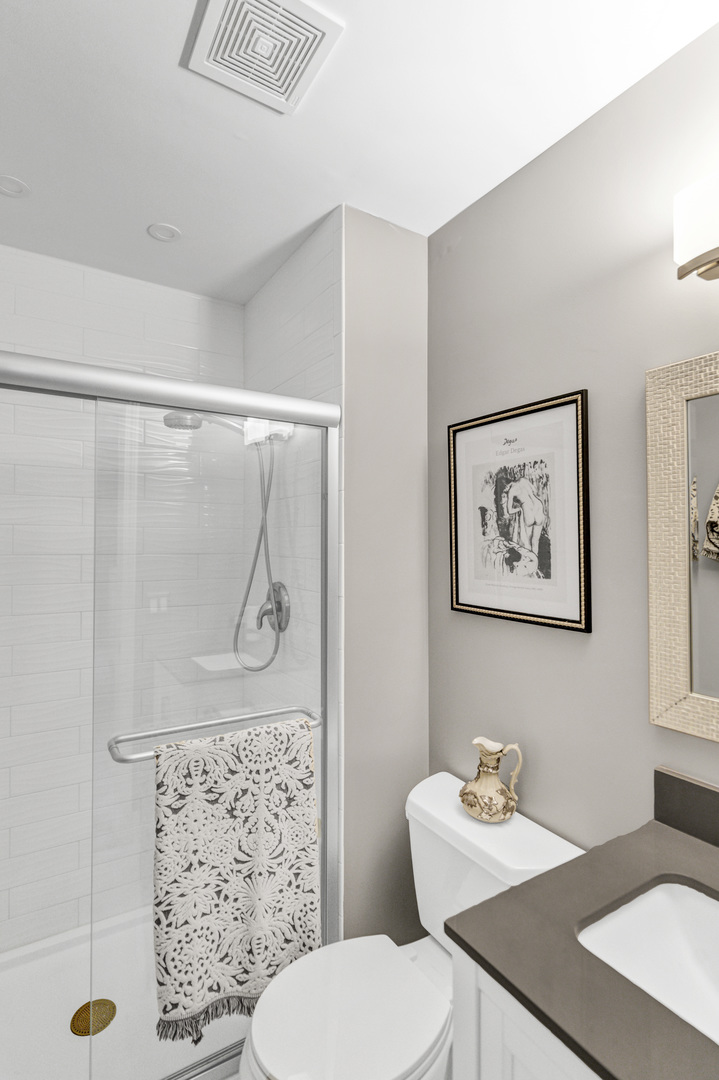 1256 Plum Tree Court, Unit D1 Schaumburg, IL 60193 - Photo 15 of 40 a bathroom with a sink mirror vanity and toilet
