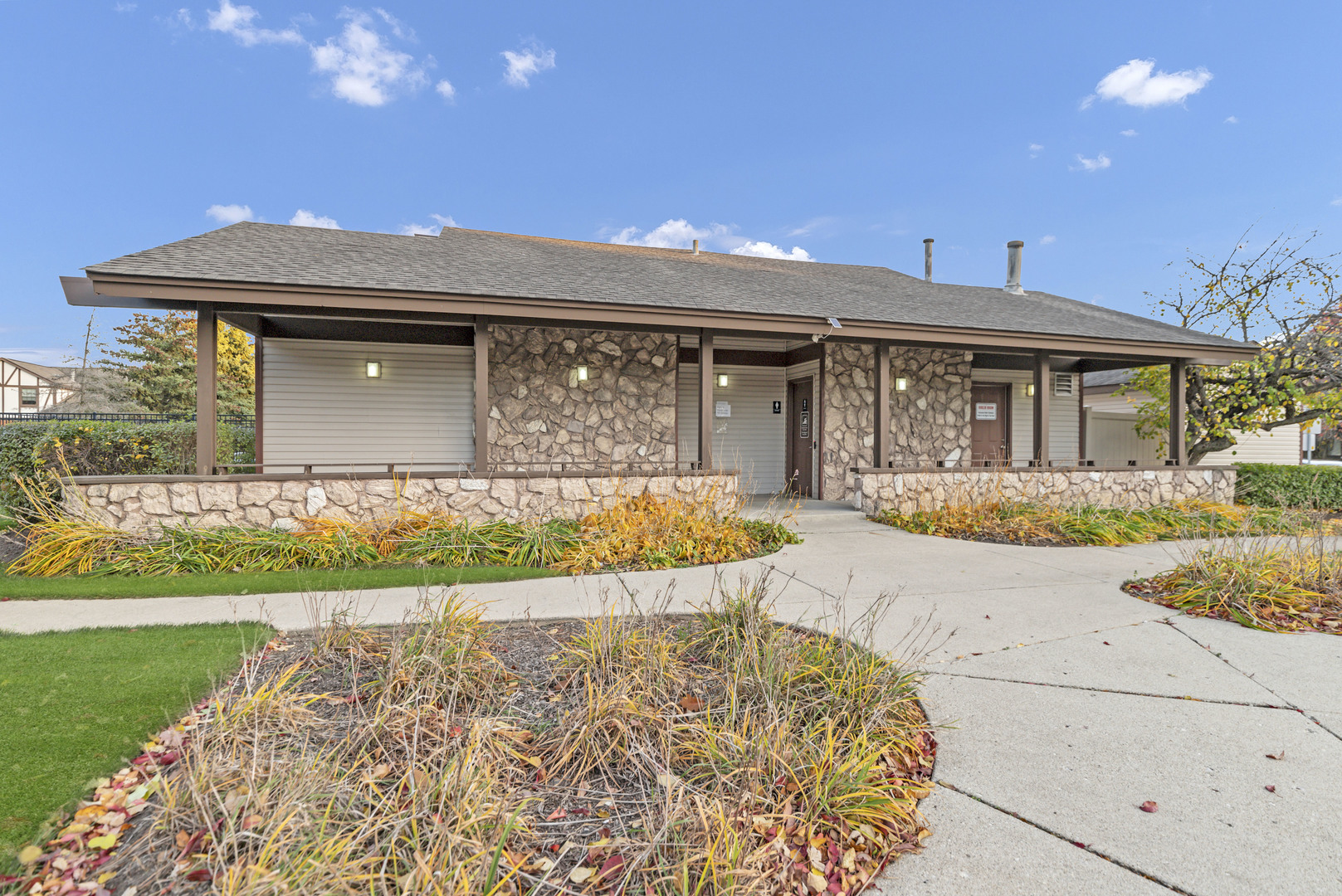 1256 Plum Tree Court, Unit D1 Schaumburg, IL 60193 - Photo 25 of 40 a front view of a house with a yard and potted plants