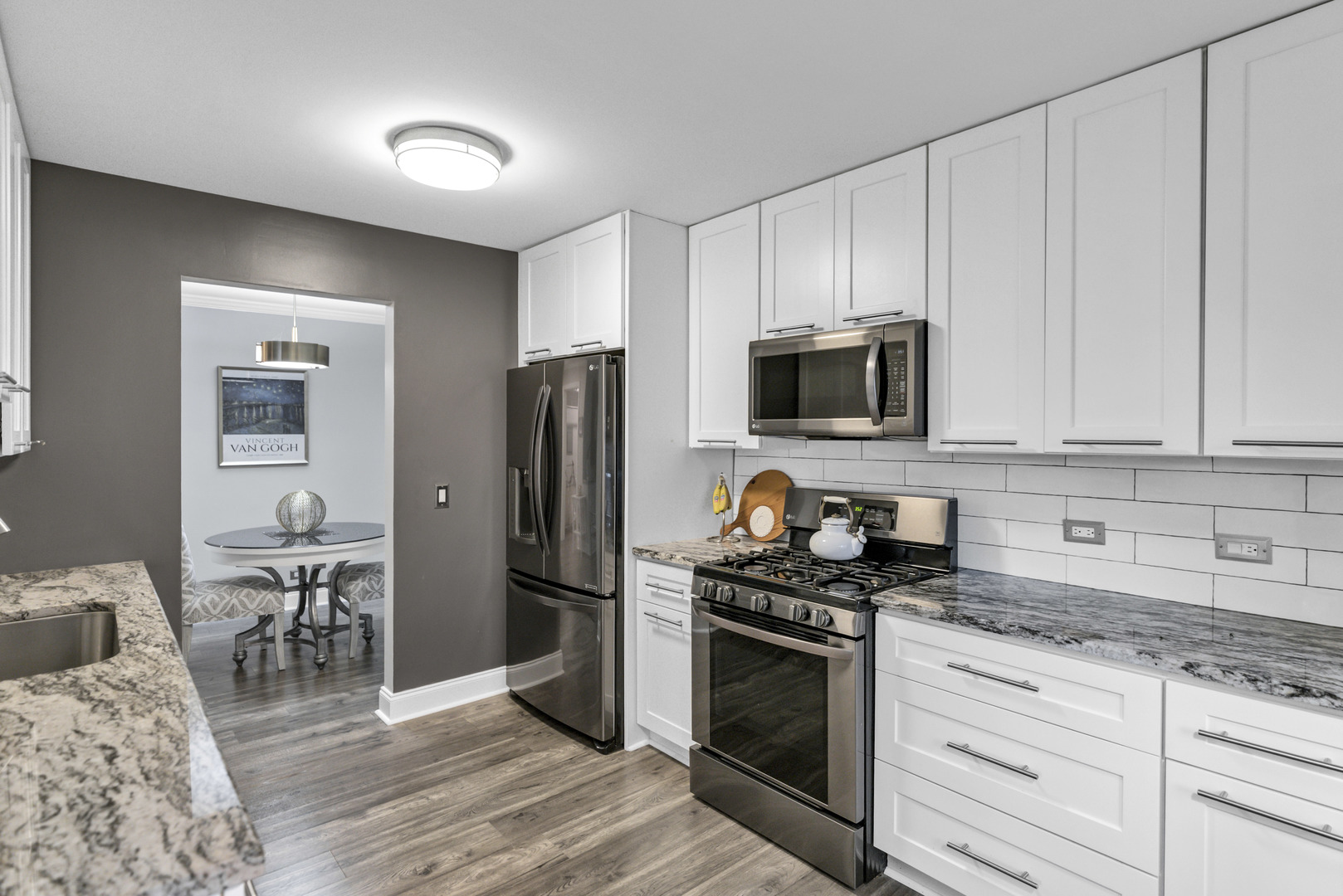 1256 Plum Tree Court, Unit D1 Schaumburg, IL 60193 - Photo 9 of 40 a kitchen with granite countertop a refrigerator stove and sink
