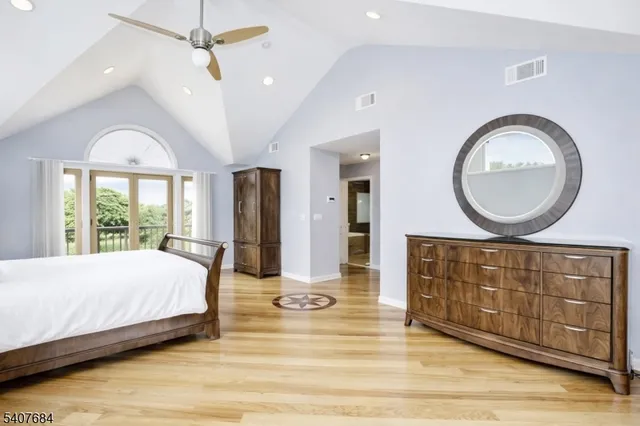 a bedroom with a large bed and a chandelier