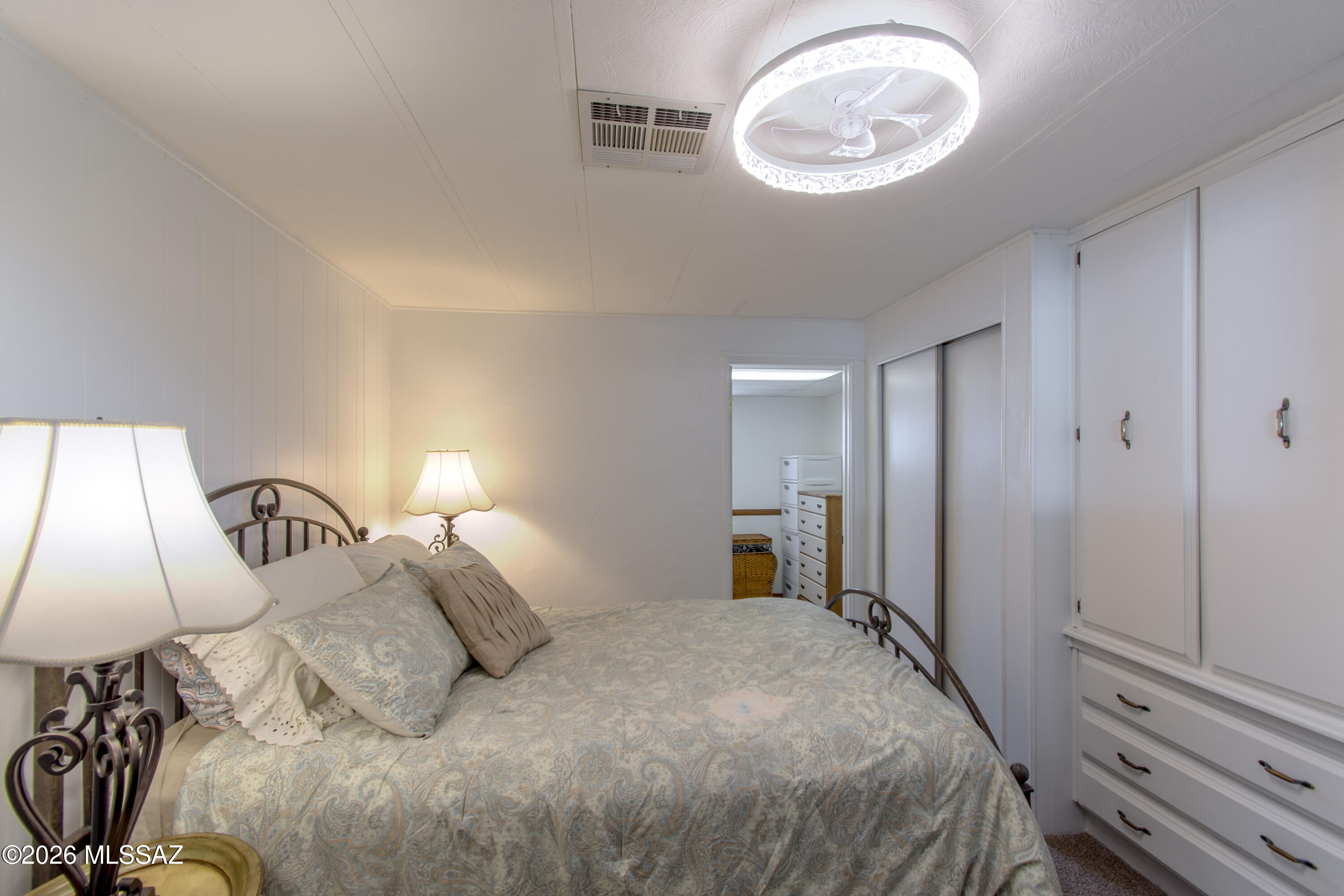 4550 North Flowing Wells Road, Unit 155 Tucson, AZ 85705 - Photo 16 of 40 a bedroom with a bed and a lamp