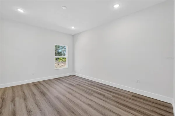 a view of room with window and hardwood floor