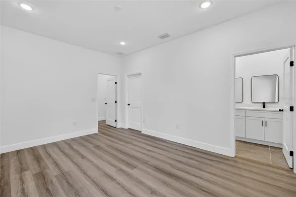 a view of a room with wooden floor and white walls