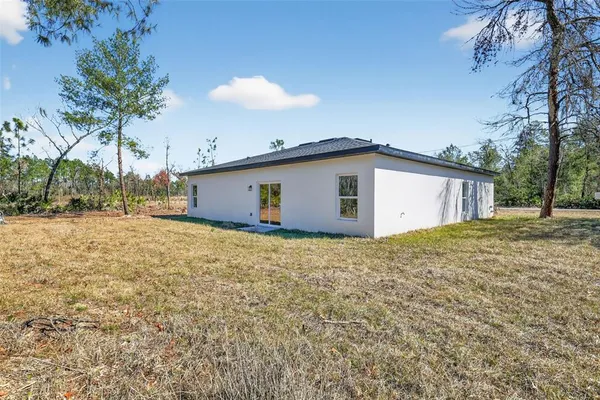 a view of a house with a backyard