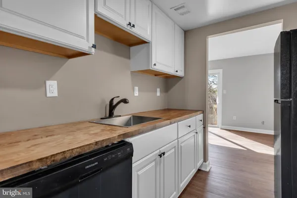 a kitchen with granite countertop a sink and cabinets