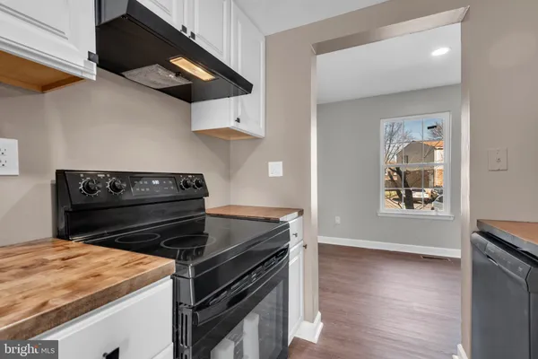 a stove top oven sitting inside of a kitchen