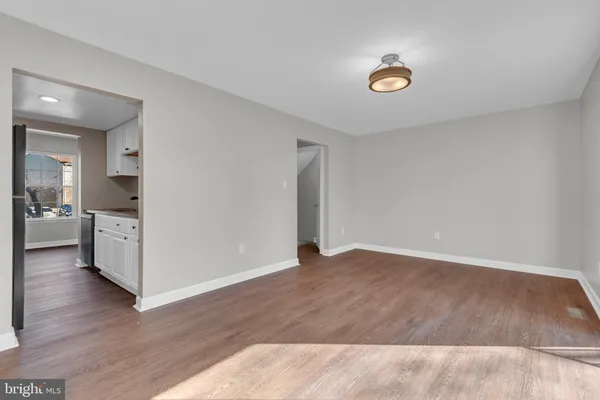 a view of a kitchen with wooden floor and a sink