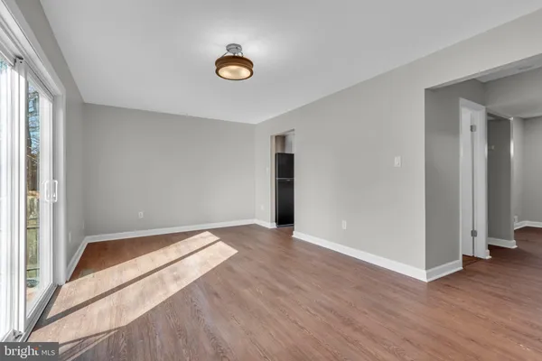 a view of an empty room and wooden floor