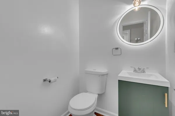 a white toilet sitting next to a bathroom sink