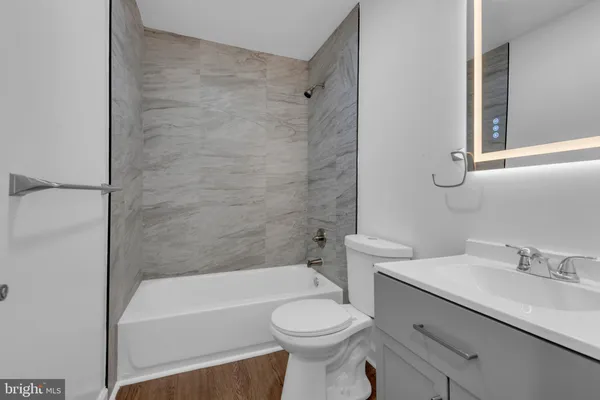 a bathroom with a sink a toilet and a bathtub