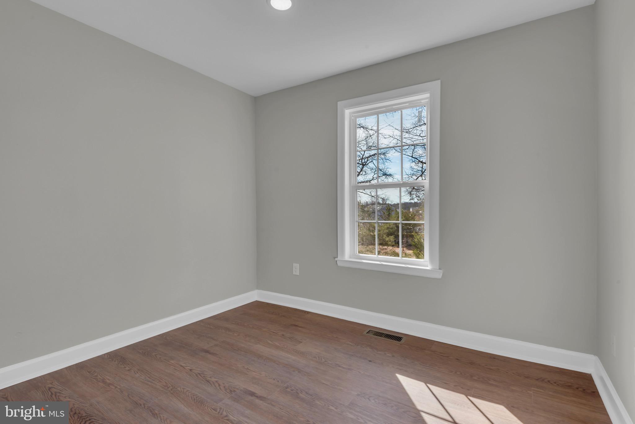 1869 Robin Court Severn, MD 21144 - Photo 30 of 43 a view of an empty room with wooden floor and a window