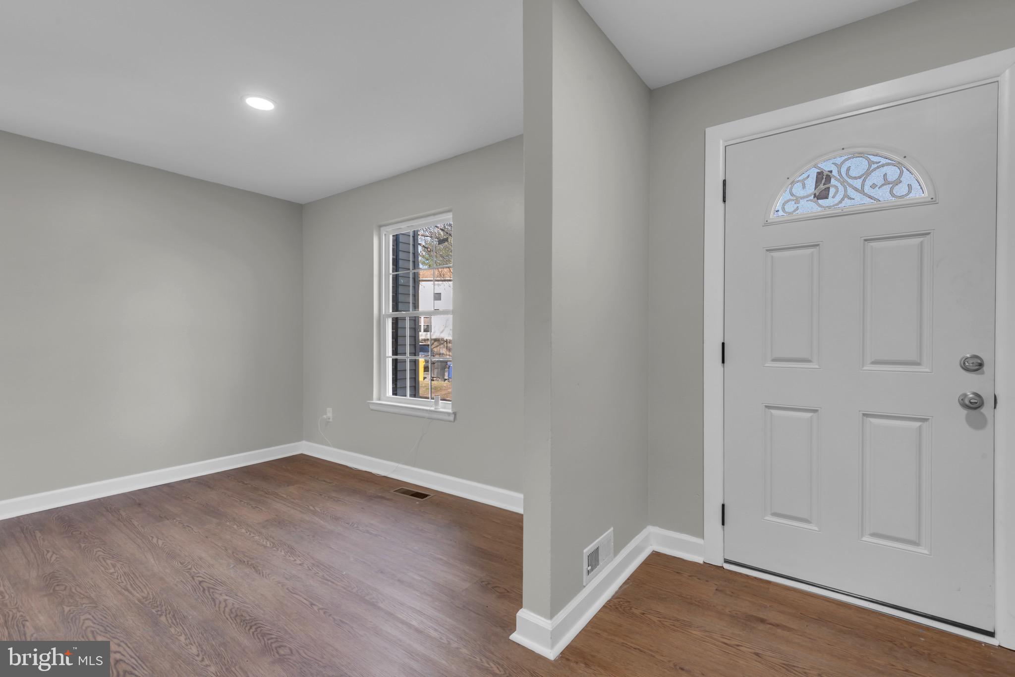 1869 Robin Court Severn, MD 21144 - Photo 5 of 43 an empty room with wooden floor and closet